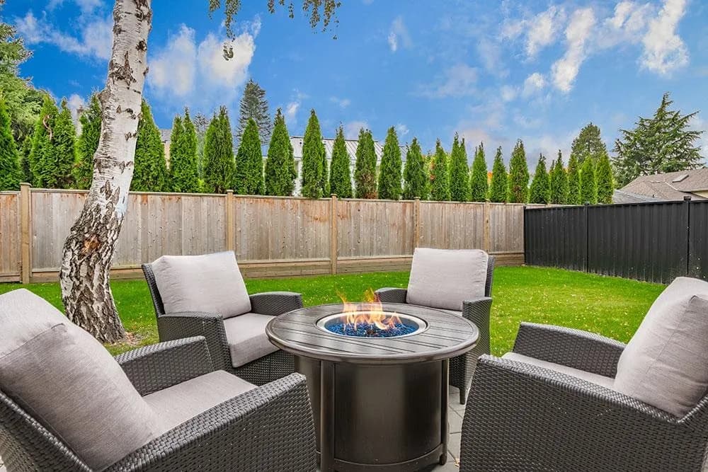 Back yard fire pit and seating area of the custom home at 12676 25 Avenue, Crescent Beach, South Surrey BC