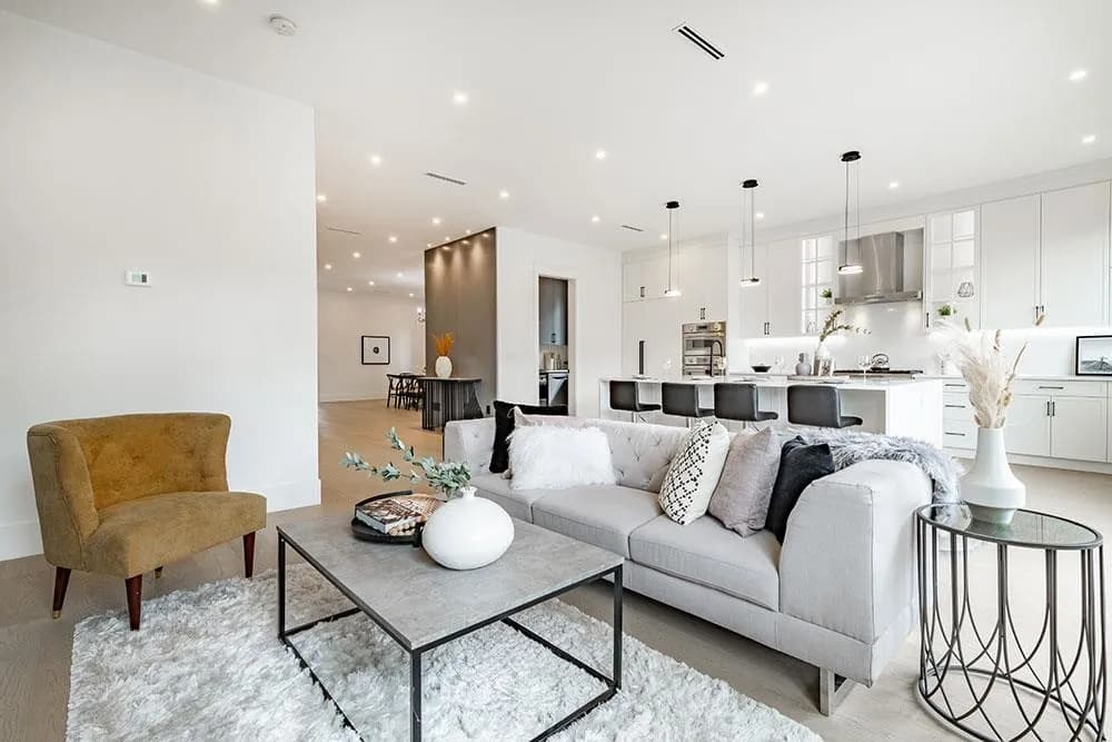 Open living area with gas fireplace flowing into the kitchen at 12676 25 Avenue, Crescent Beach, South Surrey