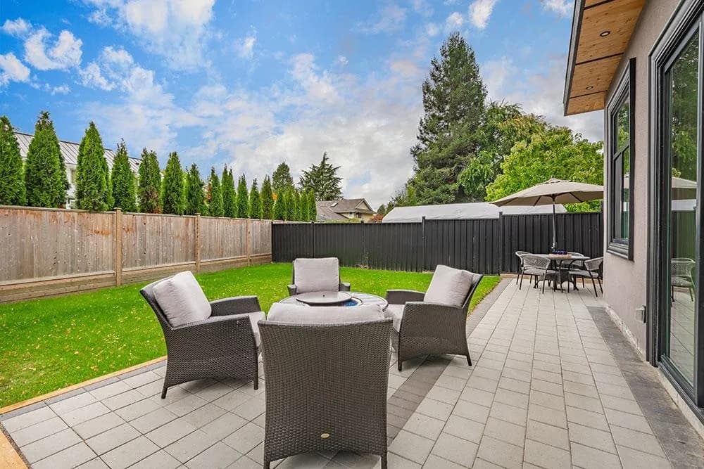 South-facing patio off the living room sliding doors with outdoor seating at 12676 25 Avenue, Crescent Beach, South Surrey