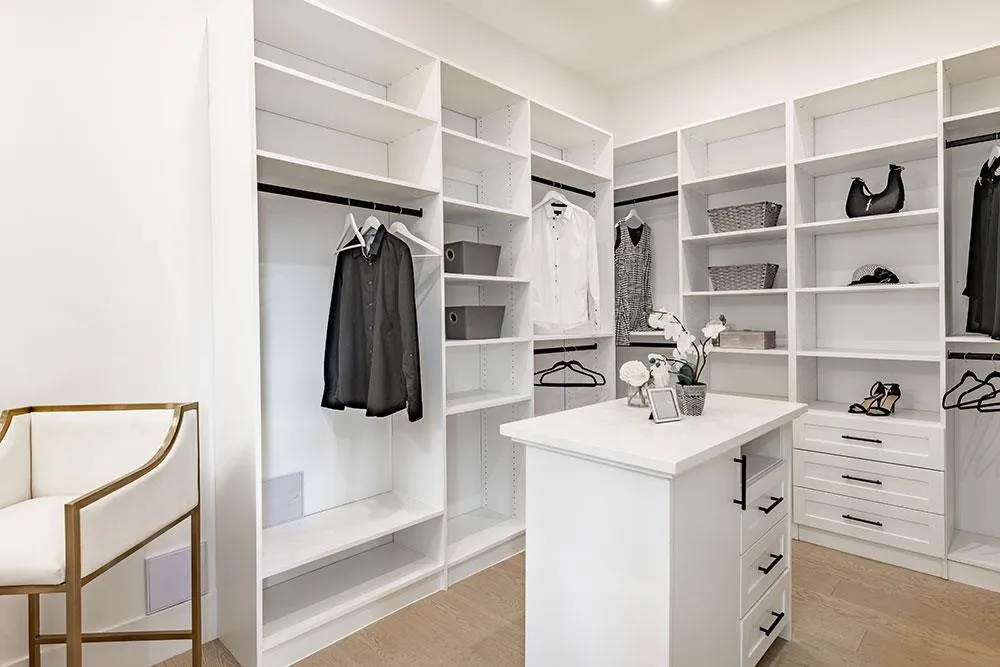 Primary walk-in closet with centre island and custom millwork at 12676 25 Avenue, Crescent Beach, South Surrey