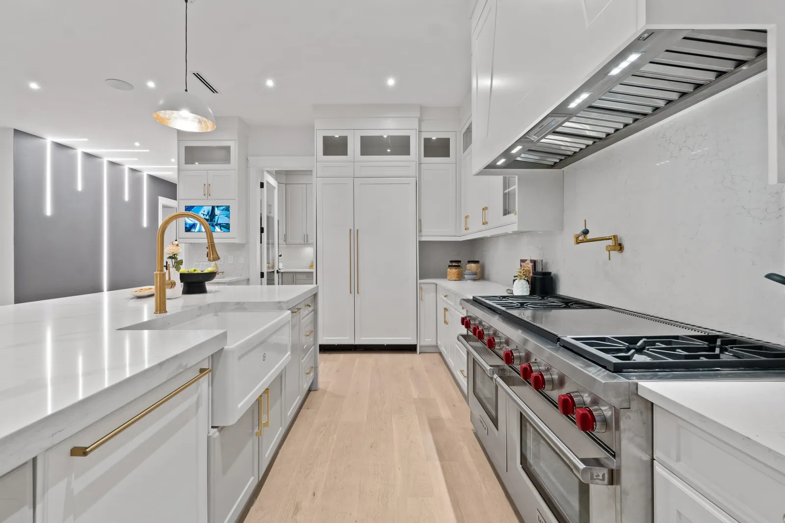 60-inch Wolf double range and Thermador appliance wall with gold hardware in a Crescent Beach custom home kitchen, South Surrey BC