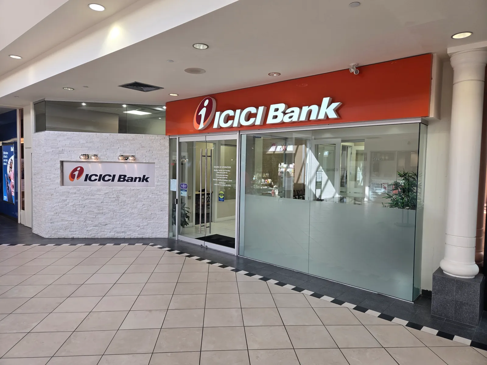 ICICI Bank Canada branch storefront at Scottsdale Centre, 7031 120 St, Delta BC — stone feature wall, glass frontage and illuminated signage built by Pro Construction Group